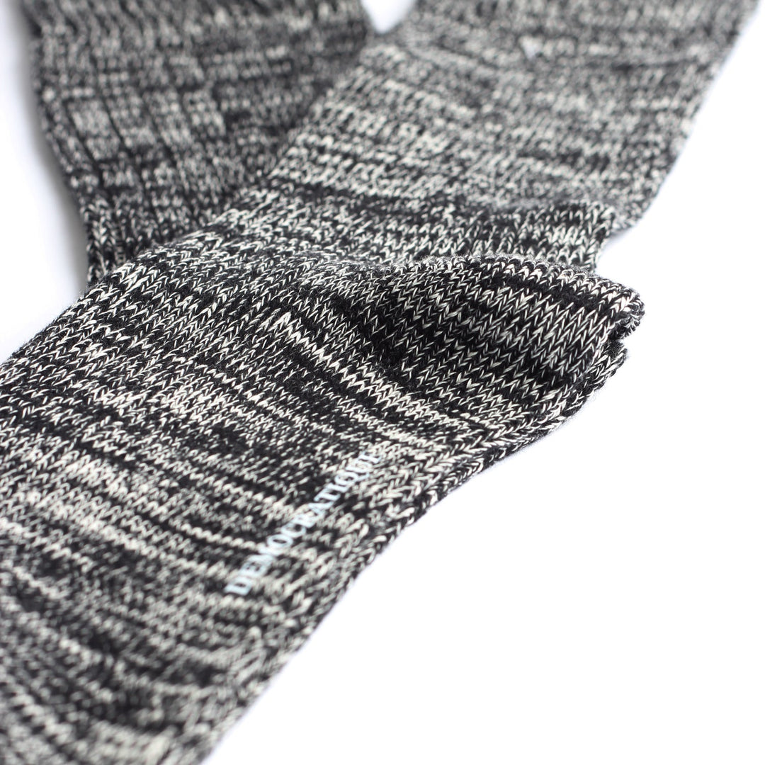 Close-up of the deep ribbed cuff on Relax Heavy Rib Supermelange socks in black and off white