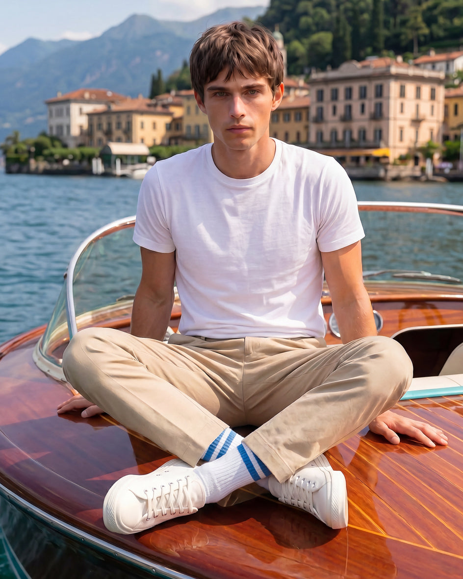 Premium men’s crew socks styled with sneakers and trousers, showing the 2026 visible sock trend from Democratique Socks at lake como
