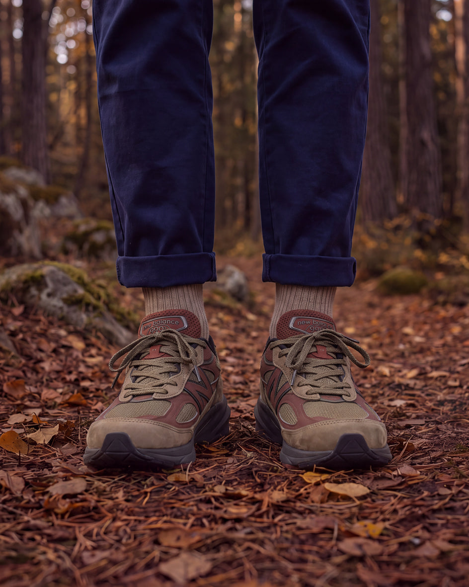autumn forest wearing Democratique Socks Originals Fine Rib in Light Khaki with New Balance sneakers — AW26 Autumn/Winter 2026 campaign.